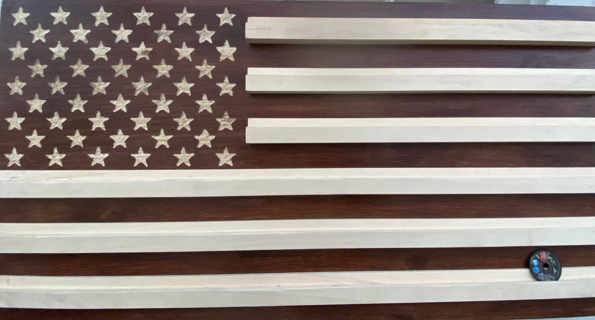 Wooden American flag on a stand outdoors