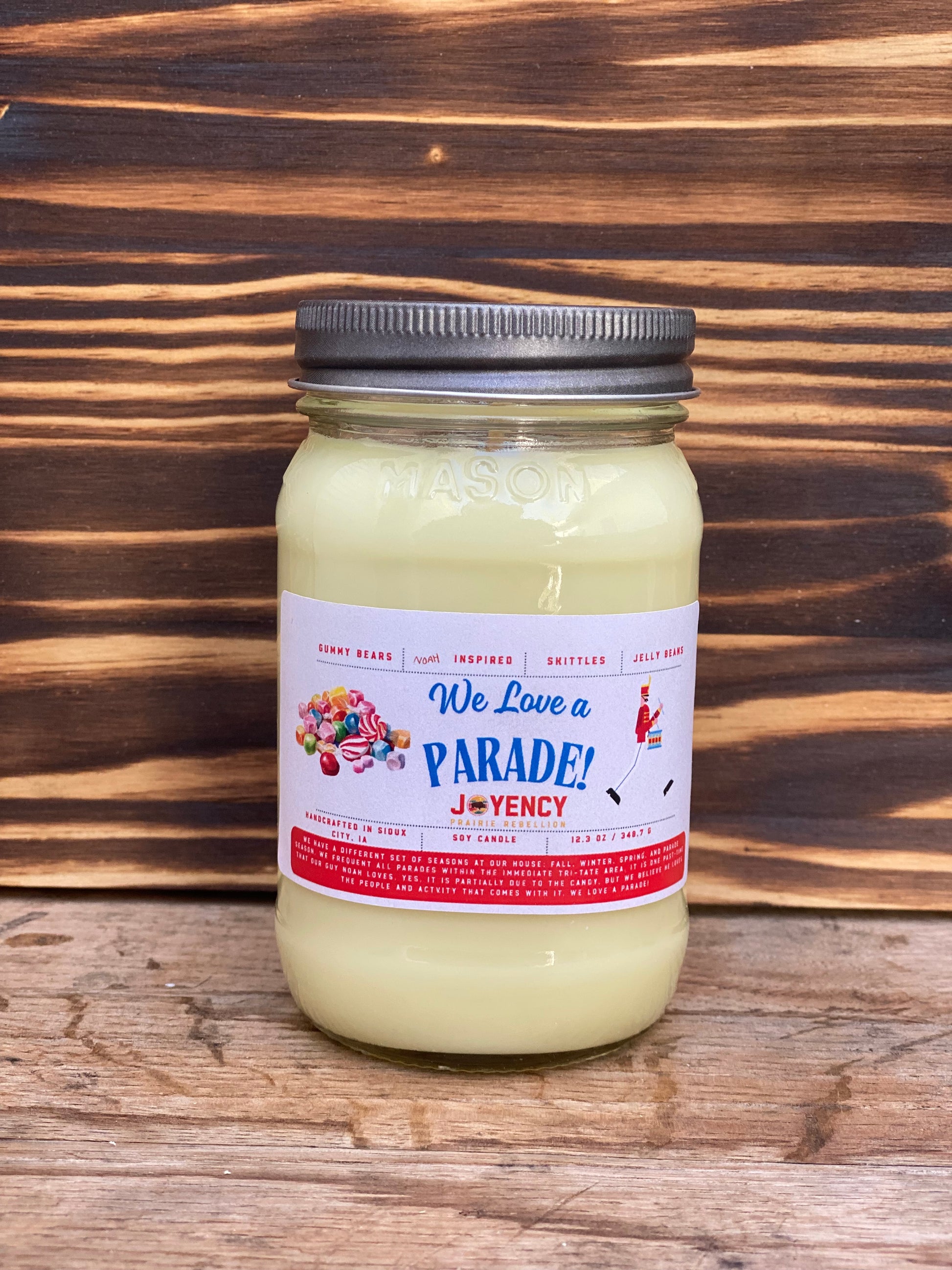 We Love A Parade hand-poured candle with gummy bears and candy background
