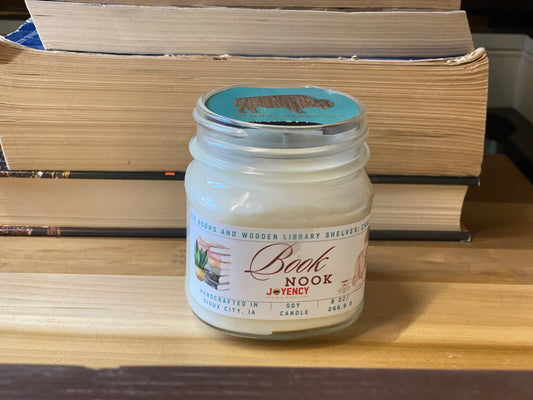 Jar labeled 'Bunk Nook' on a wooden surface with books in the background