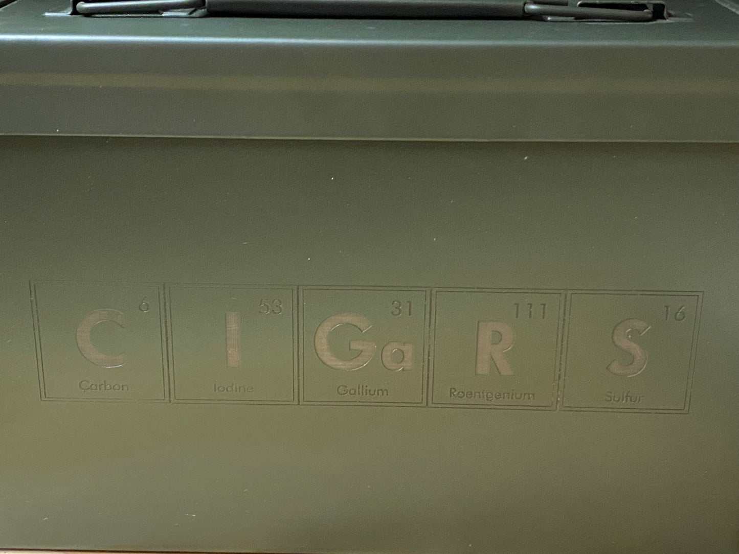 Green metal box with 'CIGARS' spelled out using chemical element symbols.