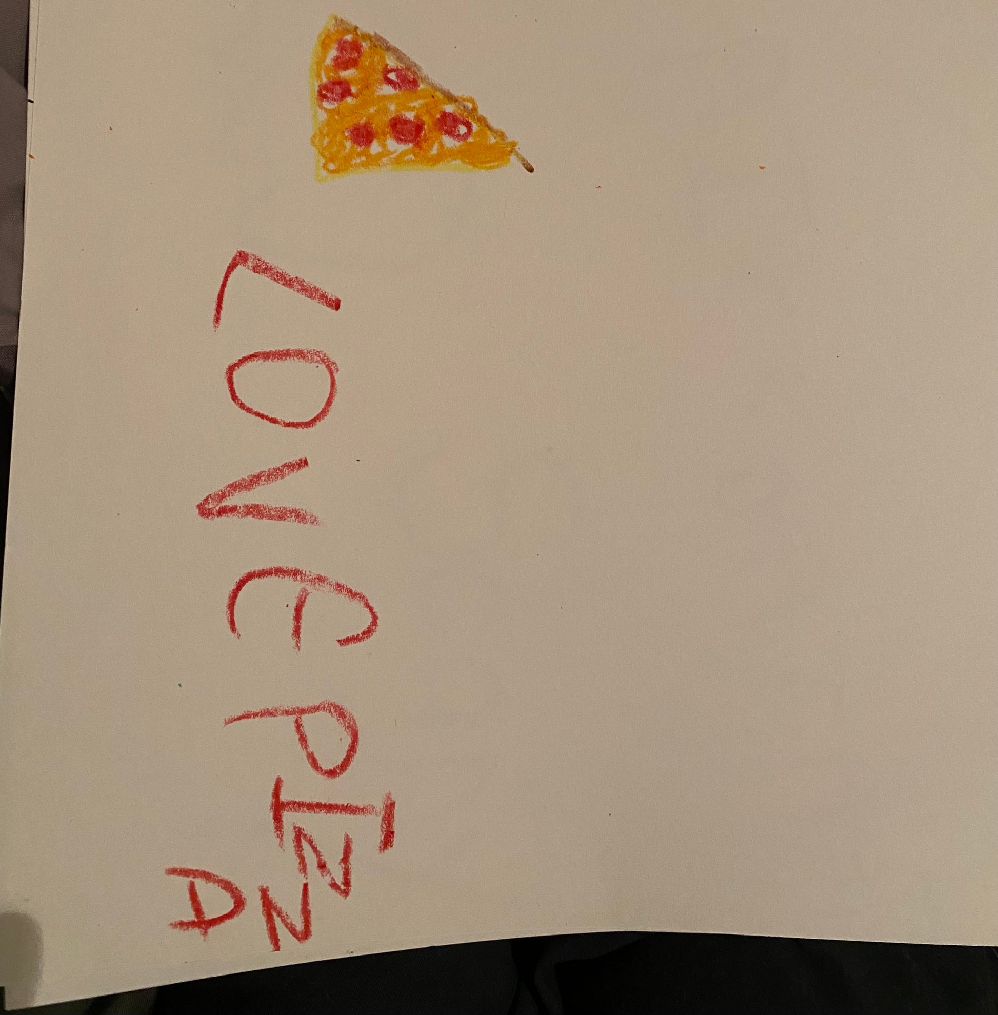 Handwritten 'LOVE PIZZA' on a piece of paper with a drawing of a pizza slice.